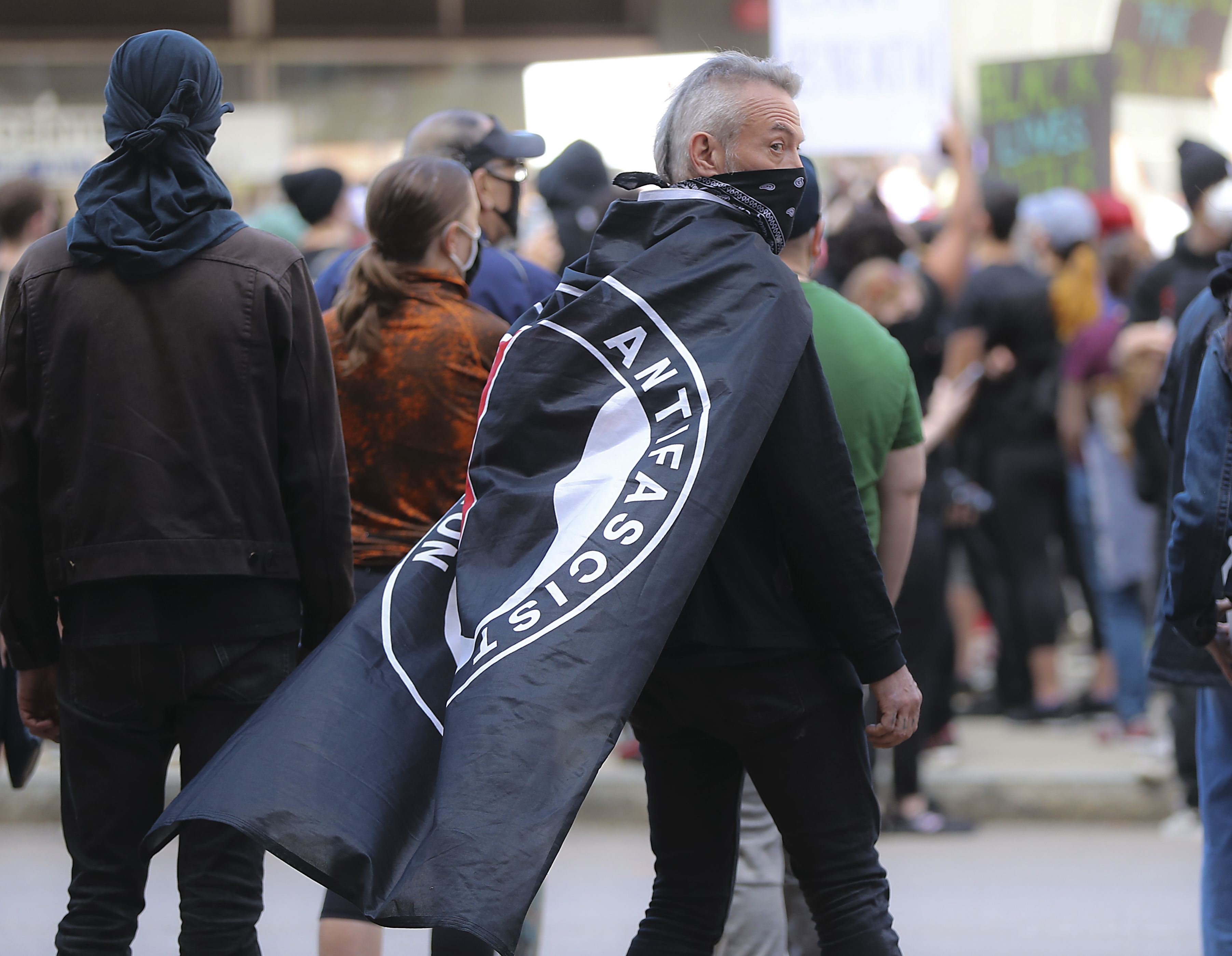 BOSTON, MA - JUNE 1: Hundreds of protesters gather at Government Center including a protester with an ANTIFA flag draped over his shoulders during a rally sponsored by the Youth of Greater Boston to demand justice for George and support of the Black Lives Matter movement in Boston on May 31, 2020, (Photo by Matthew J. Lee/The Boston Globe via Getty Images) (Matthew J. Lee/The Boston Globe via Getty Images)