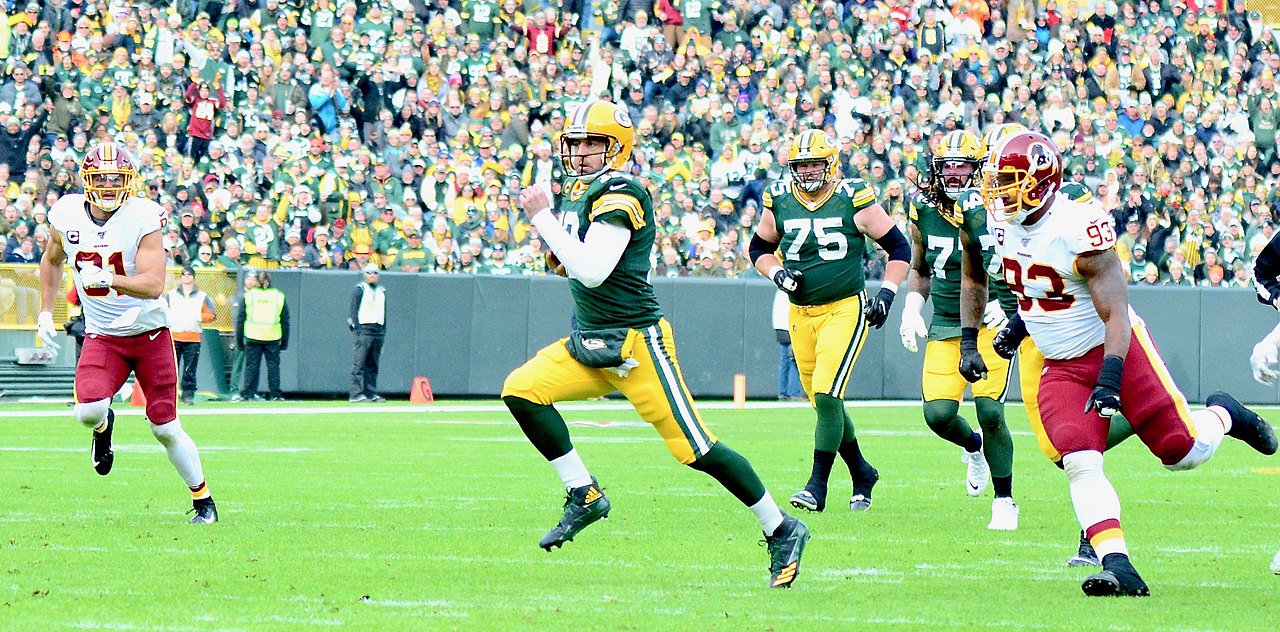 Aaron Rodgers Photographed Holding 'Stand For the Flag, Kneel for the  Cross' T-Shirt?